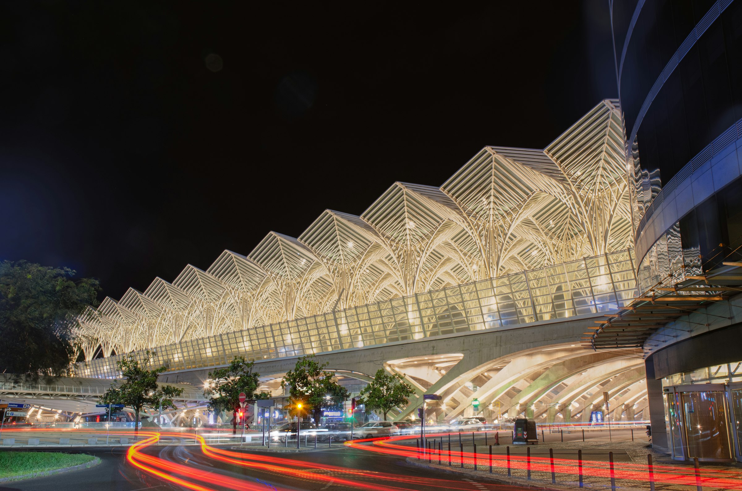 Gare do Oriente in Lisbon’s Parque das Nações business district at night, with light trails from passing traffic